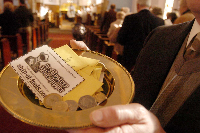 Photo of the Mystery Worshipper calling card in a collection plate